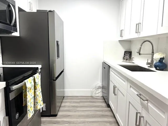a kitchen with a sink and a microwave