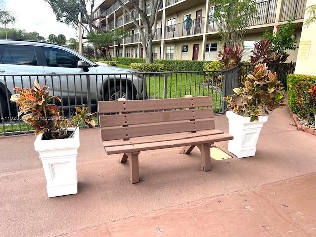 13455 Southwest 9th Court, Unit 216J Pembroke Pines, FL 33027 - Photo 54 of 66 a view of a bench in back yard of a building