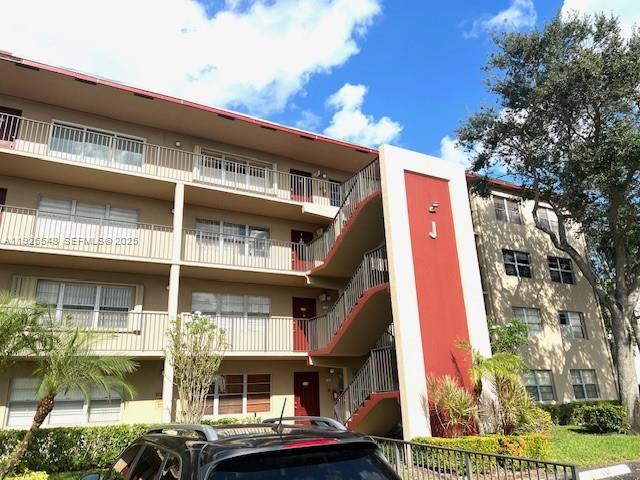 13455 Southwest 9th Court, Unit 216J Pembroke Pines, FL 33027 - Photo 65 of 66 a front view of a building with balcony