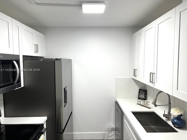 13455 Southwest 9th Court, Unit 216J Pembroke Pines, FL 33027 - Photo 7 of 66 a kitchen with stainless steel appliances a refrigerator sink and stove