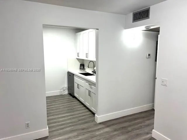 a kitchen with white cabinets and white appliances