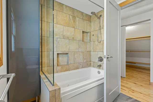 a bathroom with a bathtub and a shower