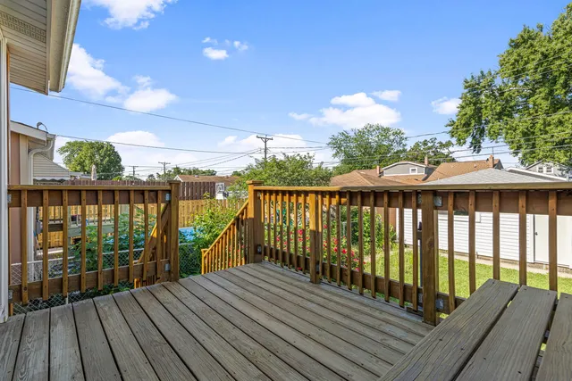 a balcony with wooden floor and outdoor space