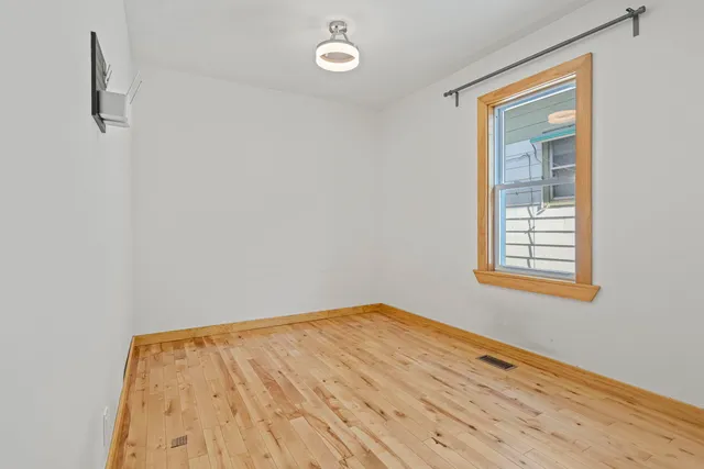 a view of a room with wooden floor and fan
