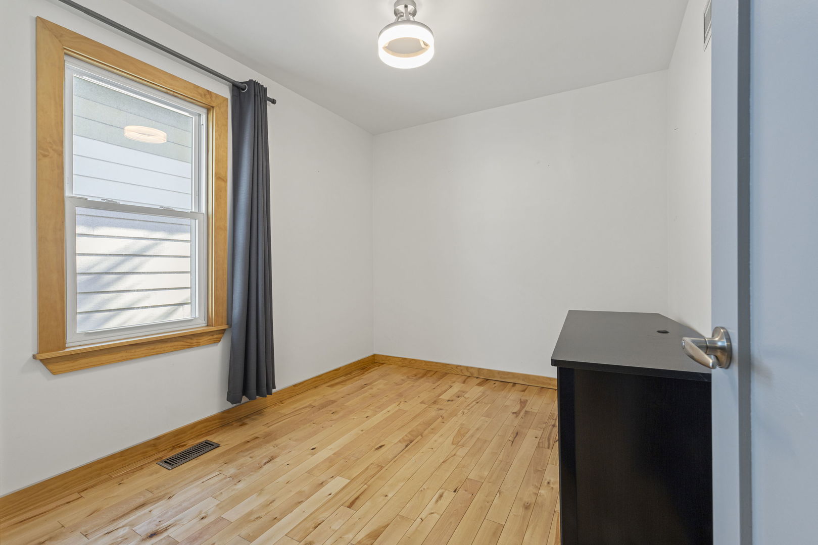 4236 North Ozark Avenue Norridge, IL 60706 - Photo 5 of 17 a view of a room with wooden floor and a window