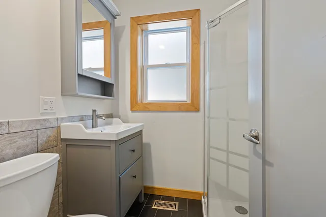 a bathroom with a sink toilet and shower