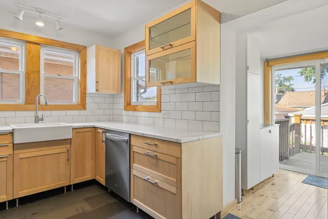 a kitchen with a sink cabinets and window