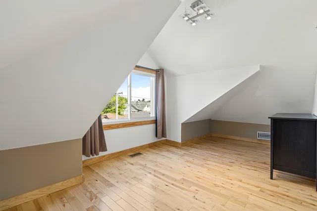 a view of an empty room and wooden floor