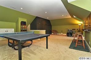 2018 Harris Road Charlotte, NC 28211 - Photo 13 of 16 a room with gym equipment and a table