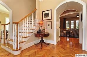 2018 Harris Road Charlotte, NC 28211 - Photo 2 of 16 a view of staircase with white walls and a glass door