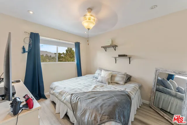 a bedroom with a bed and a chandelier