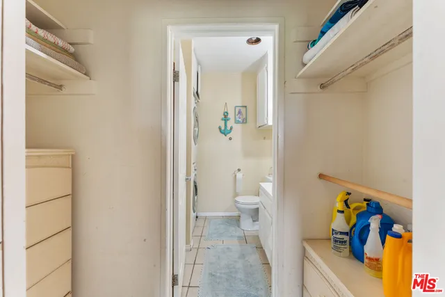 a bathroom with a toilet and a shower curtain