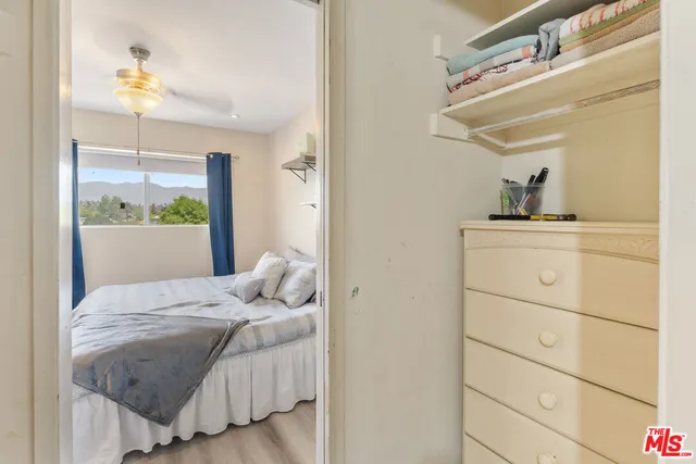 a bedroom with a bed and a mirror