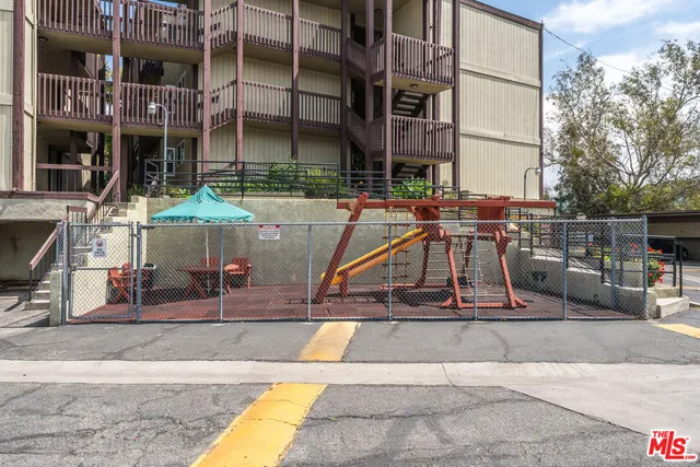 an aerial view of residential houses with outdoor space and swimming pool