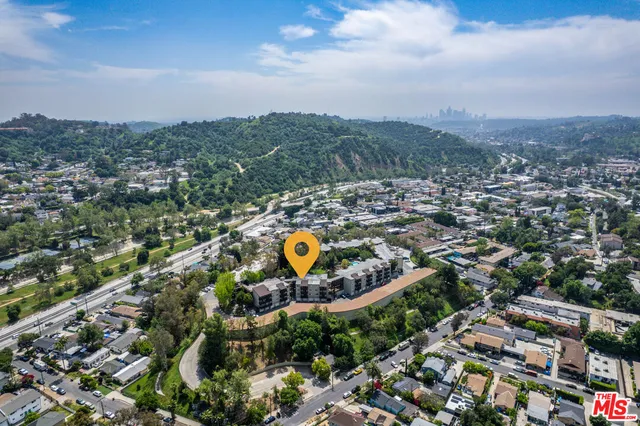 an aerial view of a house with a yard and garden