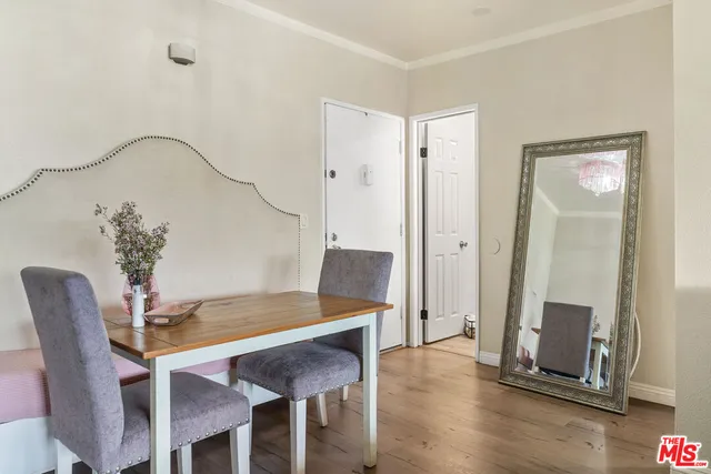 a dining room with furniture and wooden floor