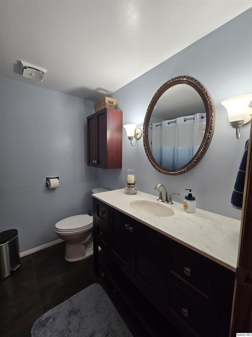 7955 Sugar Grove Road Rushville, IL 62681 - Photo 15 of 26 a bathroom with a toilet a sink and mirror