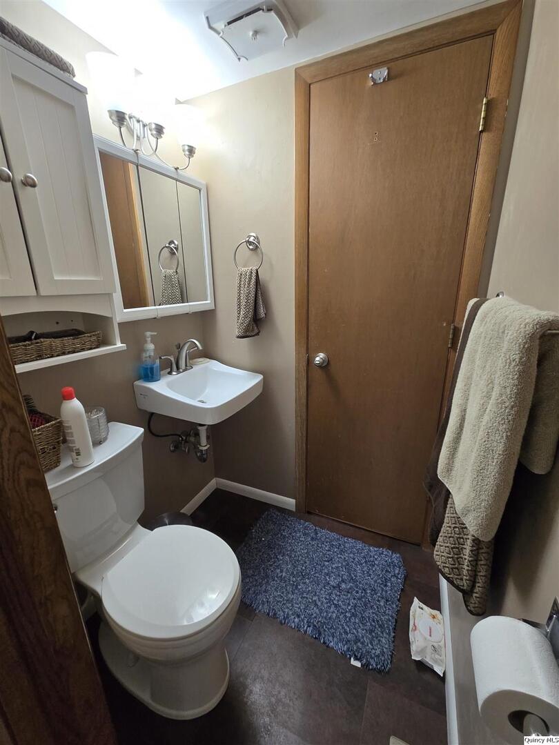 7955 Sugar Grove Road Rushville, IL 62681 - Photo 16 of 26 a bathroom with a sink toilet and mirror