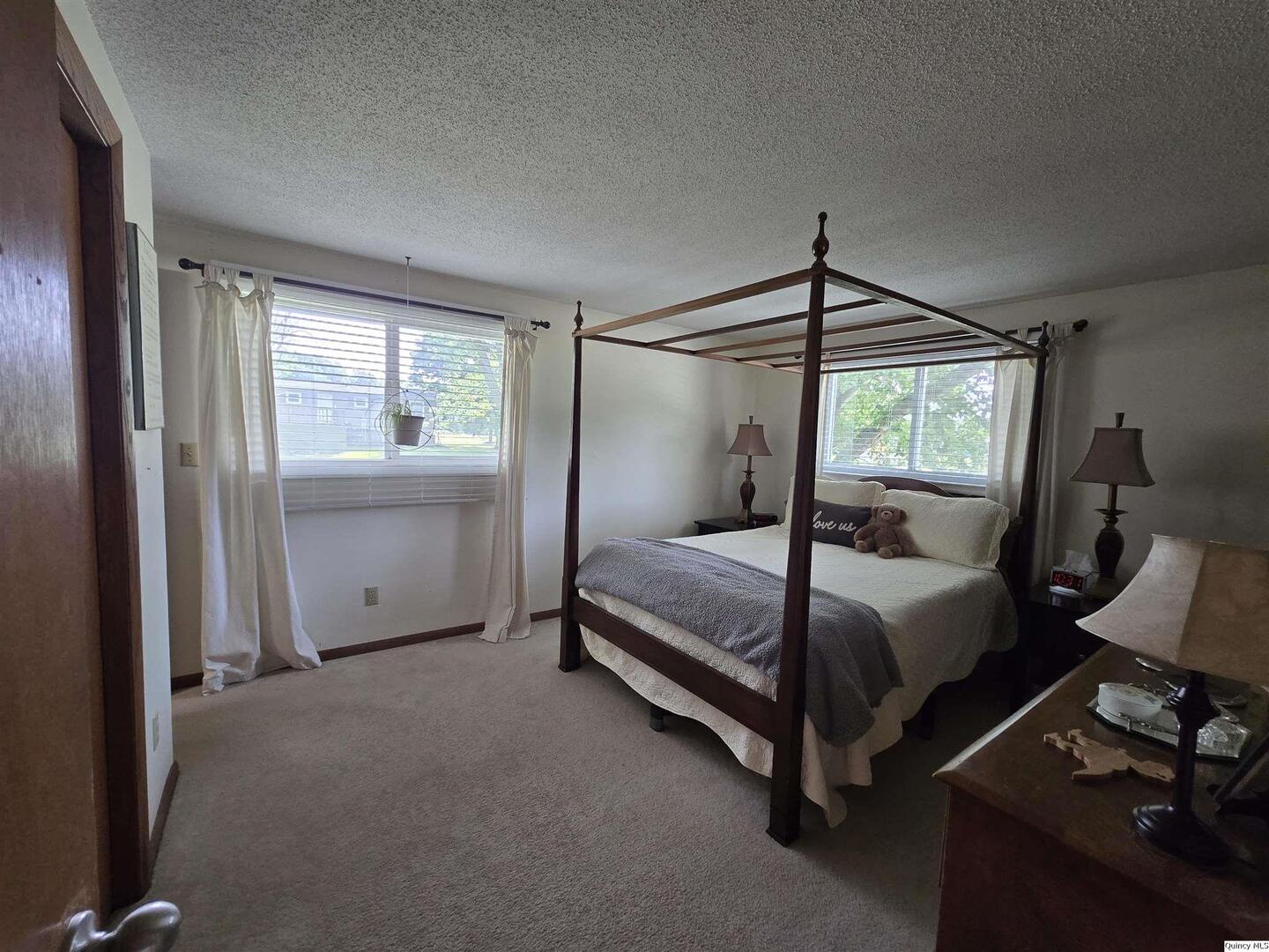 7955 Sugar Grove Road Rushville, IL 62681 - Photo 17 of 26 a bedroom with a bed and wooden floor