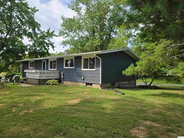 a backyard of a house with yard table and chairs
