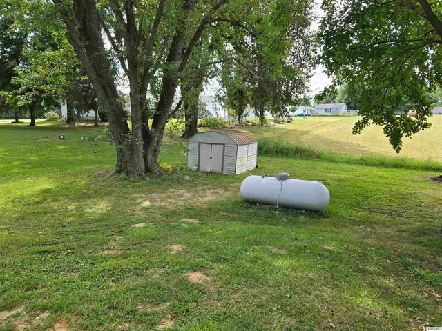 a backyard of a house with table and chairs