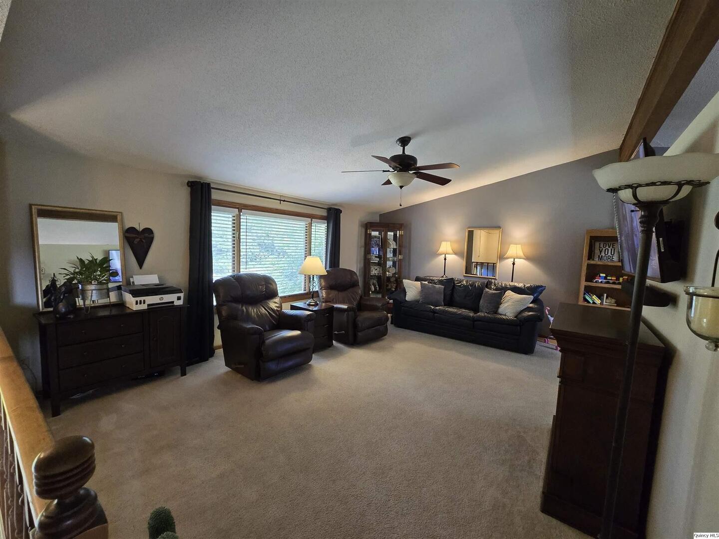 7955 Sugar Grove Road Rushville, IL 62681 - Photo 7 of 26 a living room with furniture and a chandelier