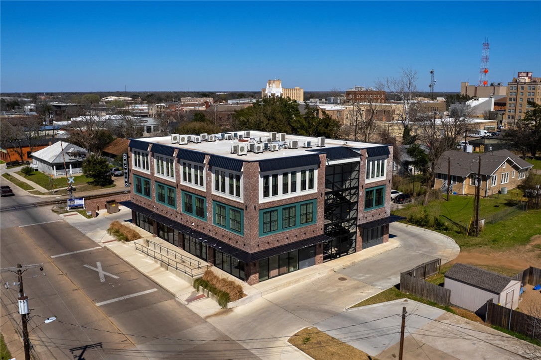 305 West 27th Street, Unit 228 Bryan, TX 77803 - Photo 17 of 17 a view of a balcony with wooden floor and city view