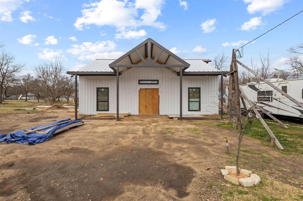 204 South Main Street Ector, TX 75439 - Photo 3 of 18 a view of a house with a yard