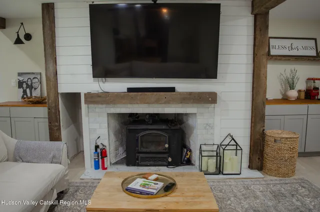 a living room with furniture a fireplace and a flat screen tv