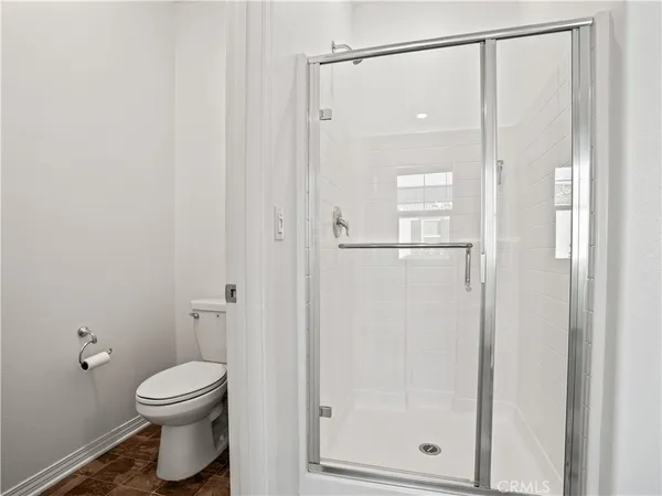 a bathroom with a toilet and a shower