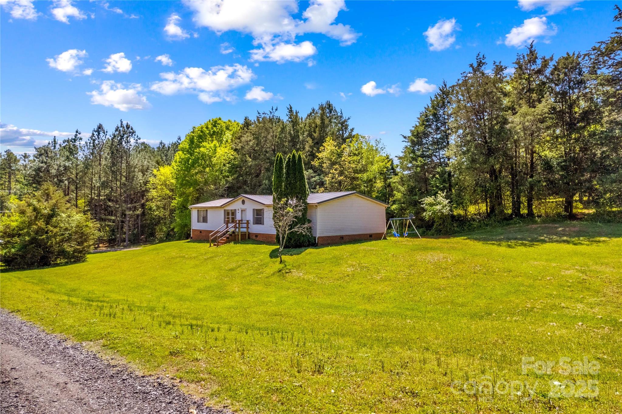 160 Ranchway Mocksville, NC 27028 - Photo 1 of 24 a big yard with table and trees in the background