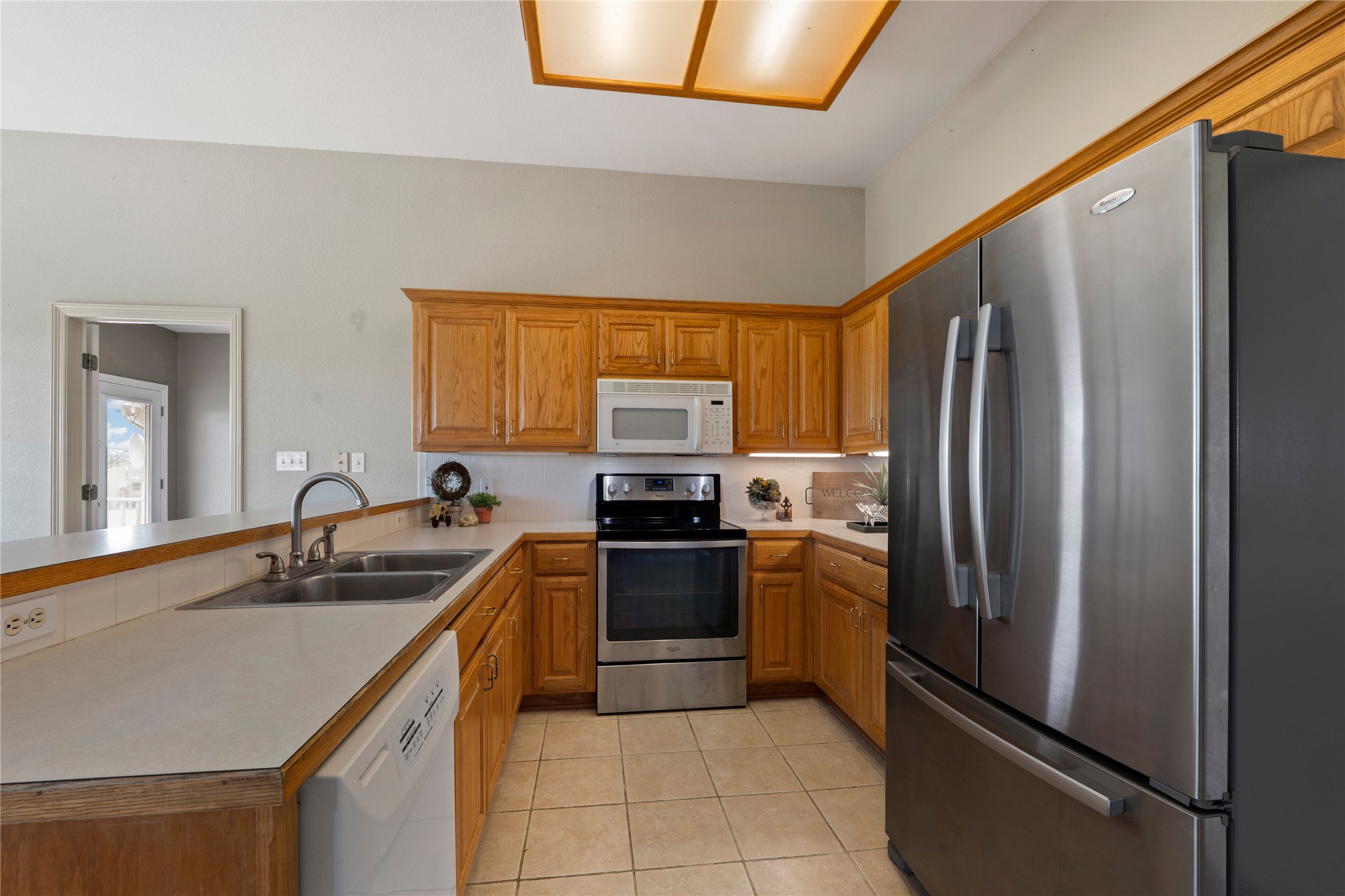 1005 East Buttercup Road Taylor, TX 76574 - Photo 19 of 38 a kitchen with stainless steel appliances granite countertop a refrigerator sink and stove