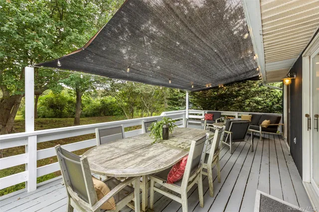 a view of a dining table and chairs on the roof deck