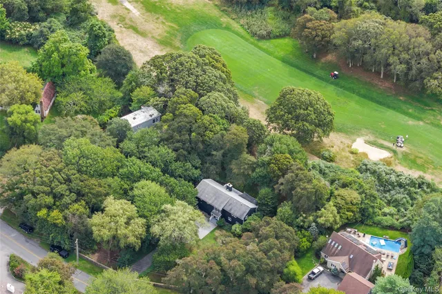 an aerial view of a house with a yard and outdoor seating