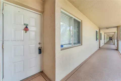a view of a hallway with closet and wooden floor