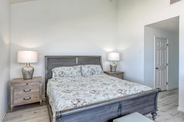 a bedroom with a bed and a lamp