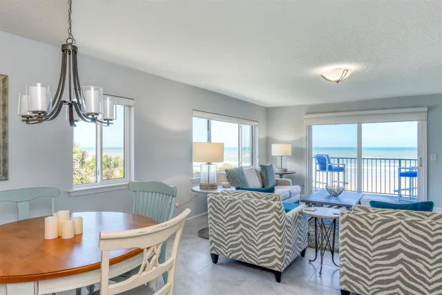a living room with furniture a flat screen tv and a large window