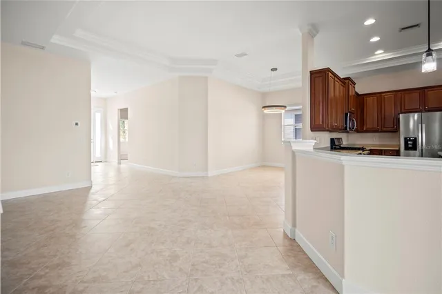 a view of a kitchen with refrigerator and windows