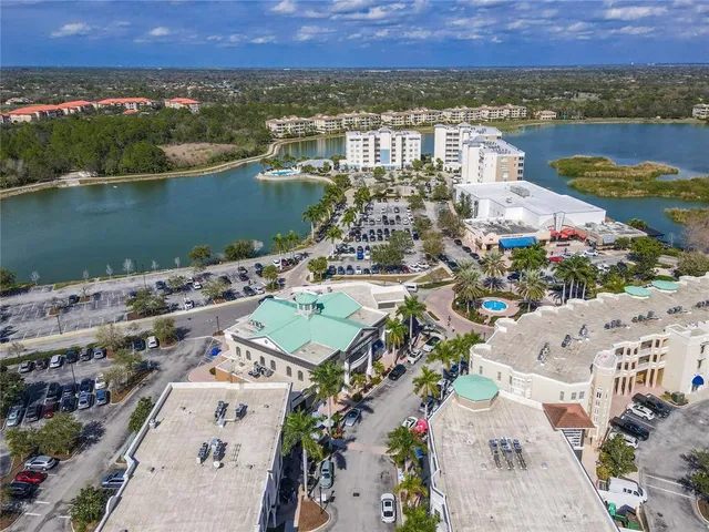 an aerial view of residential building with lake and ocean view