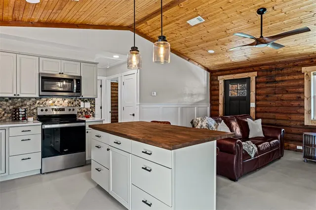 a bedroom with furniture and a kitchen