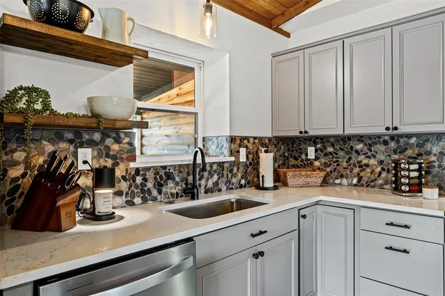 a kitchen with a sink and cabinets