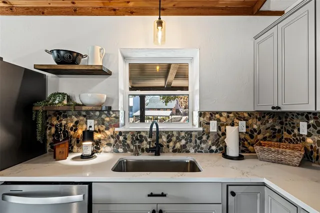 a kitchen with a sink and a stove top oven