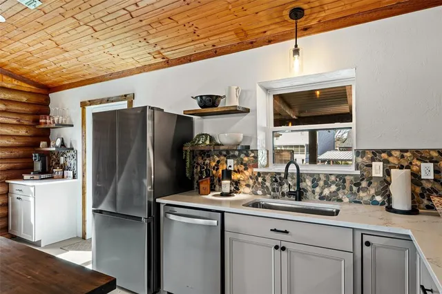 a kitchen with stainless steel appliances a refrigerator and a sink