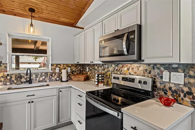 a kitchen with a stove and a microwave
