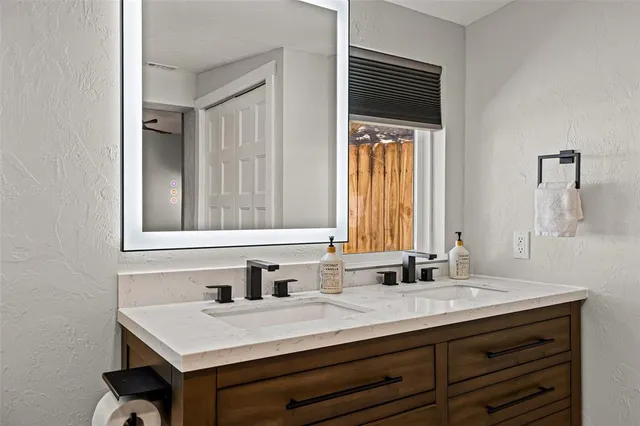 a bathroom with a sink a vanity and a mirror
