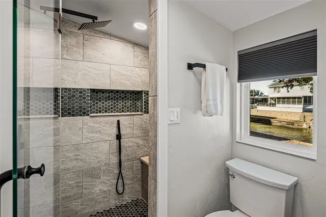 a bathroom with a shower and toilet