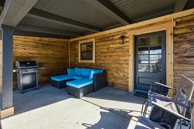 a bedroom with furniture and a large window