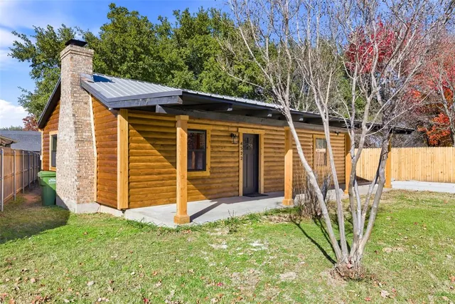 a view of a backyard with a small cabin and chair