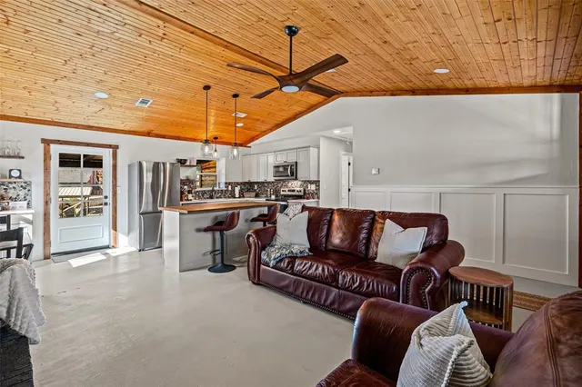 a living room with furniture and kitchen view