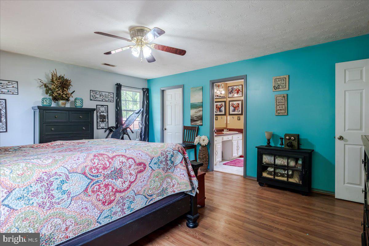 11419 Oak Grove Road Bristol, VA 24202 - Photo 21 of 36 a bedroom with a bed dresser and a large window